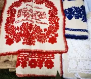 Traditional embroidered scarves in red, white and blue with floral patterns and decorations.
