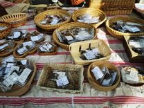 Seed packets in various baskets and bowls on a set table.